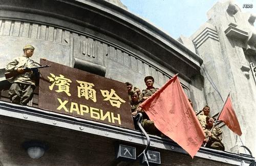 Soviet troops flying the red flag atop the train station at Harbin, Songjiang, China, circa 20 Aug 1945, photo 1 of 2