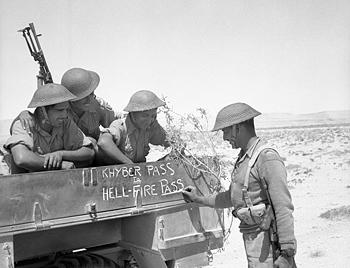 Troops of the Indian 4th Division decorating the side of their truck with 'Khyber pass to Hellfire Pass', noting their service in South Asia and North Africa, 21 Jun 1941