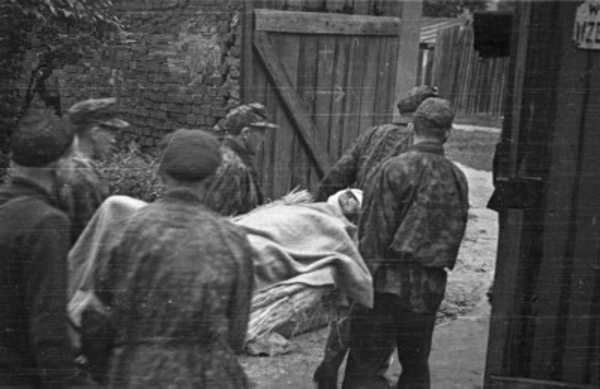 Wounded Polish resistance fighter being evacuated from the Evangelical Cemetery, Warsaw, Poland, early Aug 1944