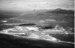 Crossed runways of Barbers Point Naval Air Station on the Ewa Plain, Oahu, Hawaii looking north with the Wai’anae Mountains in the background, Oct 1965
