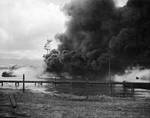 Battleship Arizona burning and settled on the bottom as seen from Ford Island, Pearl Harbor, Oahu, Hawaii, Dec 7, 1941.