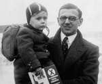 Nicholas Winton holding a child, probably in Prague, Czechoslovakia, probably in 1938.