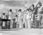 Admiral Chester Nimitz, Rear Admiral Marc Mitscher, and others salute the National Anthem during Sunday morning colors at Kaneohe Naval Air Station, Hawaii, 8 Nov 1942