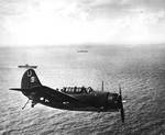An SB2C Helldiver of Bombing Squadron VB-7 flying over USS Hancock off Formosa (Taiwan), 13 Oct 1944