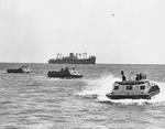 US Marine Corps LVT(1) amphibian tractors moving toward Guadalcanal, Solomon Islands, 7-9 Aug 1942; note USS President Hayes in background