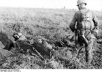 German soldier looking at killed Soviet soldiers, 1941-1942