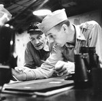 Carrier Task Force Commander Vice Admiral John McCain and Operations Officer Commander John Thach (fighter Ace) going over operational plans aboard USS Hancock during the Philippine campaign, Nov 1944 to Jan 1945.