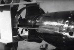 A still image taken from a US Navy training film showing the tail ring modification to the Mark XIII torpedo with a sailor holding a break-away wooden tail shroud that will go around it, 1945.