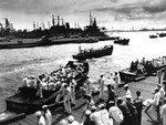 Liberty parties returning from Honolulu board LCVPs in Pearl Harbor to return to their ships, 9 May 1945. The LCVPs are from attack transports USS Hyde, USS Colusa, and USS Effingham.