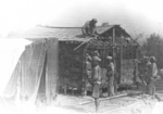 Members of US 5332nd Brigade (Provisional) building quarters for its colonel with locals, Burma, 1945, photo 1 of 4