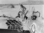 Pilot Officer Kennedy of No. 47 Squadron RAF Detachment inspecting his Wellesley bomber after engagement with two CR.42 fighters, Agordat, Eritrea, 25 Mar 1941; his gunner Sergeant German was killed