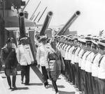 Benito Mussolini reviewing a warship, Taranto, Italy, 21 Jun 1942; note Angelo Iachino and Arturo Riccardi behind Mussolini, and sailor Antonio Angelo Caria sixth from right who released this photo into public domain