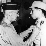 Lieutenant General Joseph Stilwell awarding the Silver Star to Chinese pilot Captain Tsang Hsi-lan for actions in the air during the Battle of Changsha, early 1942.