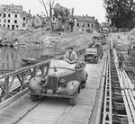 Field Marshal Montgomery stands up in his 1943 Humber Super Snipe staff car as he crosses a pontoon bridge over the River Seine at Vernon, France, 1 Sep 1944.