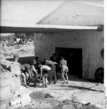 German troops pushing a 5 cm PaK 38 gun into a building, Italy, 1944, photo 2 of 2