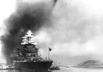 Battleship USS Maryland in Berth F5, Pearl Harbor, Hawaii, 7 Dec 1941. Note capsized USS Oklahoma at right, USS Tennessee behind Maryland, and smoke from burning USS Arizona in the background.