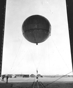 A captured Japanese paper Fu-Go Type A balloon bomb, reinflated for testing, being wheeled out of the blimp hangar at Naval Air Station Moffett Field, Mountain View, California, United States, 27 Aug 1945.