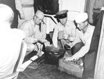 US Navy personnel searching briefcases of Japanese Navy officers in the wardroom of USS Nicholas, 27 Aug 1945 prior to entry into Tokyo Bay for the surrender ceremony a week later.