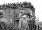 A crowded tower at RAF Thurleigh, Bedfordshire, England, 1944-45 with men awaiting the return of bombers of the 306th Bomb Group.