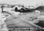 Royal Navy Avenger aircraft flying from HMS Indomitable in flight over Ishigaki Airfield, Ishigaki, Okinawa, Japan, 9 May 1945; note fire and explosions on the airfield