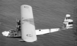 P2Y-1 aircraft of US Navy squadron VP-10F in flight, 1930s; note four-star flag near cockpit indicating an admiral was onboard