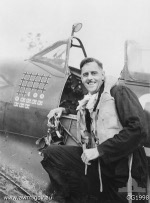Australian Group Captain Clive R. Caldwell of No. 80 (Fighter) Wing RAAF next to his Spitfire Mk VIII aircraft, Halmahera, Morotai Islands, Dutch East Indies, circa Dec 1944