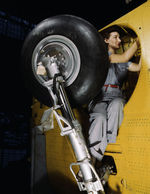 Female employee of Vultee working in the wheel well of a Vengeance dive bomber, Nashville, Tennessee, United States, Feb 1943