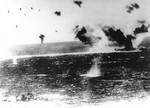Lexington under attack during Battle of Coral Sea, photographed by a Japanese pilot, 8 May 1942; destroyer Phelps at bottom of photo