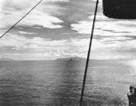 Destroyer sailed between Guadalcanal and Tulagi, Savo Island in distance, circa late 1942
