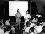 Captain William Sterling Parsons and Colonel Paul Tibbets, Jr. briefed the crew of B-29 Superfortress 