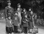 Members of the Mochida family awaiting evacuation bus to internment camp, California, United States, 8 May 1942