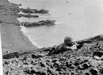 US Marine on Mount Suribachi, with landing craft in the background, Iwo Jima, Japan, 19-23 Feb 1945