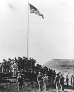 The official flag raising at the American Headquarters on Iwo Jima immediately after Nimitz