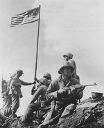 Men of 28th Regiment, US 5th Marine Division putting up the first flag on Mount Suribachi, Iwo Jima, Japan, at 1020 hours on 23 Feb 1945; note M1 Carbine
