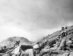Men of USMC 5th Division advancing through the volcanic ash hills of Red Beach No. 1 at Iwo Jima, Japan, 19 Feb 1945, photo 2 of 2