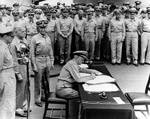 Nimitz signing the instrument of surrender, Tokyo Bay, Japan, 2 Sep 1945, photo 1 of 2