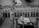 MacArthur signing Japanese surrender aboard USS Missouri, 2 Sep 1945, photo 4 of 4
