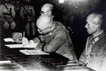 Rikichi Ando signing the surrender document, Taipei City Hall, Taiwan, 25 Oct 1945; note Haruki Isayama on the right of the photograph