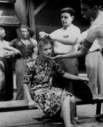 A French mob shaved the head of a French girl as punishment for having personal relations with a German soldier, Montélimar, France, 29 Aug 1944