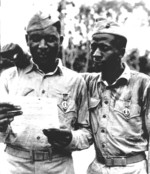 African-American US Marines Staff Sergeant Timerlate Kirven and Corporal Samuel J. Love, Sr. having just been awarded Purple Heart medals, Saipan, Mariana Islands, 1944