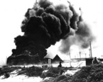 Oil tanks burning on Sand Island of Midway Atoll after Japanese attack, 4 Jun 1942