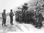 Two New Zealand soldiers guarding a group of German prisoners of war, Monte Cassino, Italy, Mar 1944
