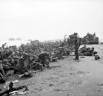 British troops crouching down on Sword Beach, Normandy, France, 6 Jun 1944