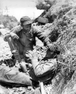 Man of US 1st Marine Division comforting a fellow Marine who had just witnessed the death of a friend, Okinawa, Japan, May 1945