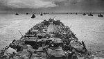 Columns of troop-packed American LCI landing craft in the wake of a USCG-manned LST en route to Cape Sansapor, New Guinea, mid-1944