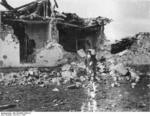 Spanish civilian checking out a building destroyed in the Battle of Guadalajara, Spain, Mar 1937