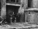Polish resistance fighters of the Ruczaj Battalion guarding entrance of the Mala PASTa building at Piusa 19 Street (now 19 Piekna Street), Warsaw, Poland, circa 24 Aug 1944