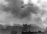 Ju 87 Stuka dive bomber over the Sródmiescie district of Warsaw, Poland during the Warsaw Uprising, mid-Aug 1944