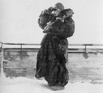 A Finnish woman of Lotta Svärd in heavy coat watching the sky for Russian aircraft, Northern Finland, Jan 1940