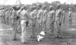 Lieutenant Colonel Frazier presenting WW2 Victory Medal to African-American US Marines of 51st and 52nd Defense Battalions, Camp Gilbert H. Johnson, Montford Point, Jacksonville, North Carolina, United States, 1945
